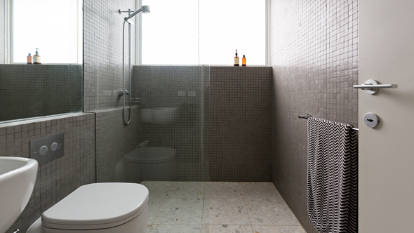 modern wet room with white utilities and dark grey square tiling