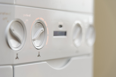 combi boiler close up of heating buttons and dials for water temperature settings